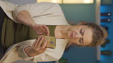 Vertical-video-of-Home-office-worker-woman-having-problems-and-stress-on-the-phone.